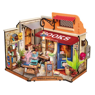 Rolife Corner Bookstore DG164 – farverig DIY miniature boghandel med rød ‘BOOKS’‑markise, blå dør, brosten og varmt LED‑lys.